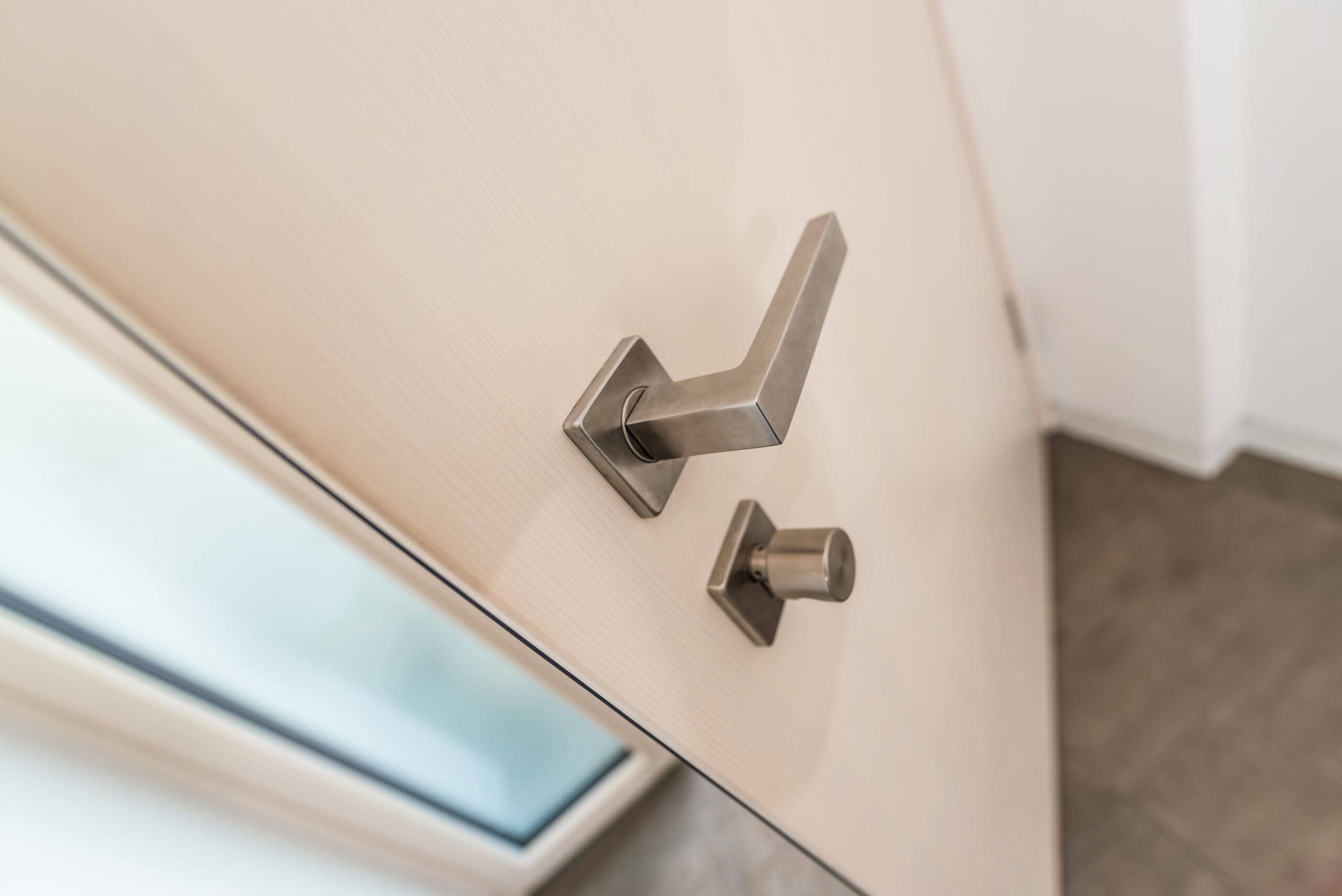 Nahaufnahme Eingangstür aus hellem Holz mit Türgriff und Sperrfunktion